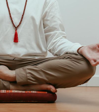 Close-up of a person's hands in a specific yoga mudra gesture.